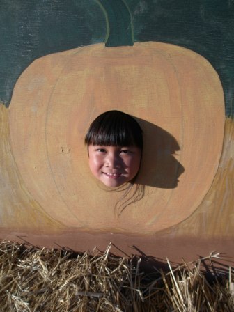 Kasen's head in a pumpkin cutout